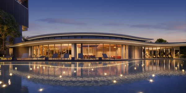 Evening view of River Green Condo clubhouse and swimming pool with luxury lounge chairs and illuminated water reflections in Singapore's District 9